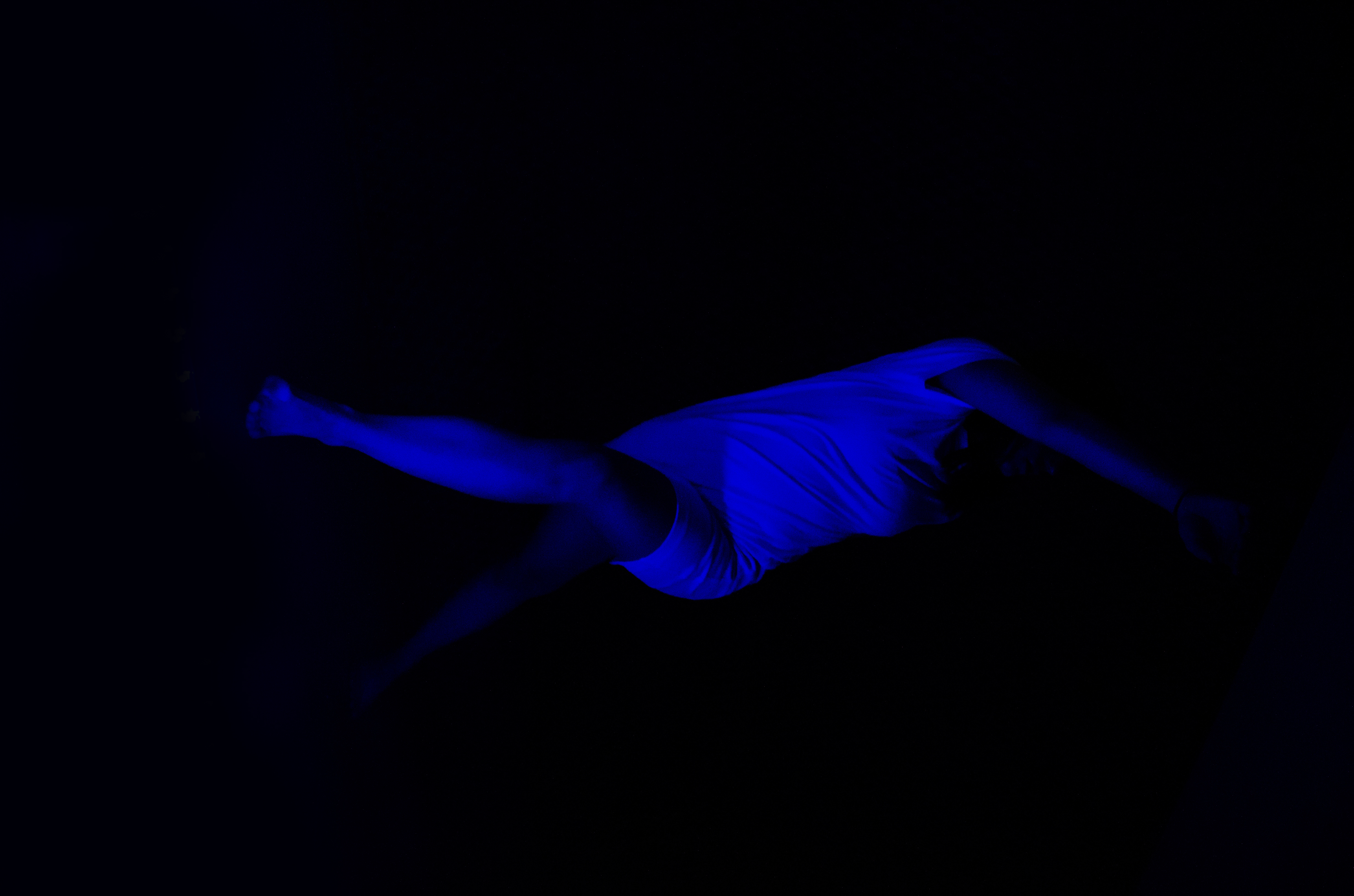 a blue body against a dark black background